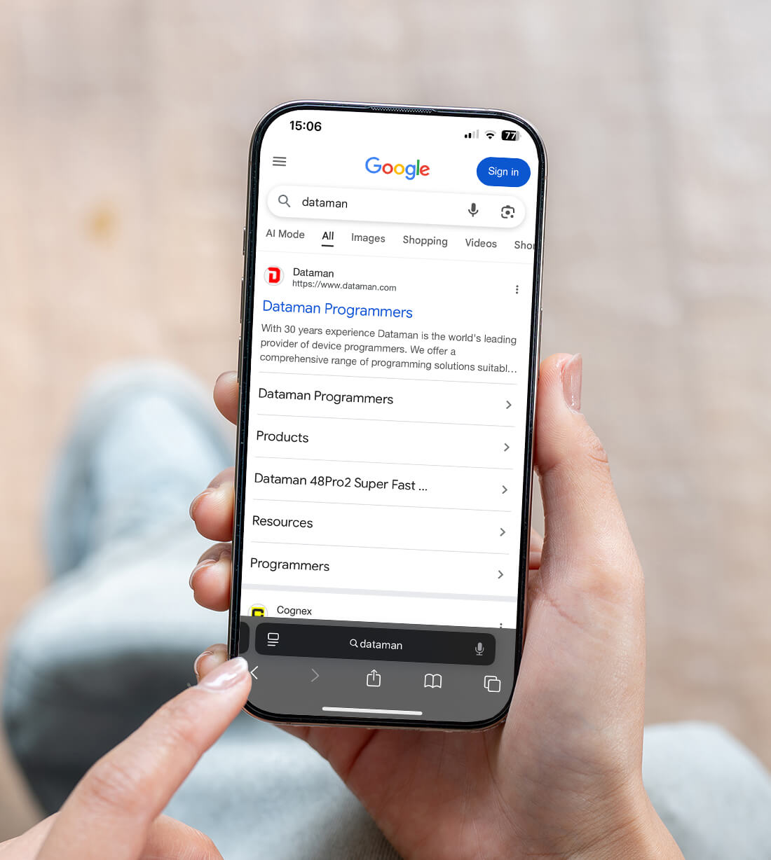 Person holding a smartphone with Google search results for Dataman following Shopify technical SEO optimisation