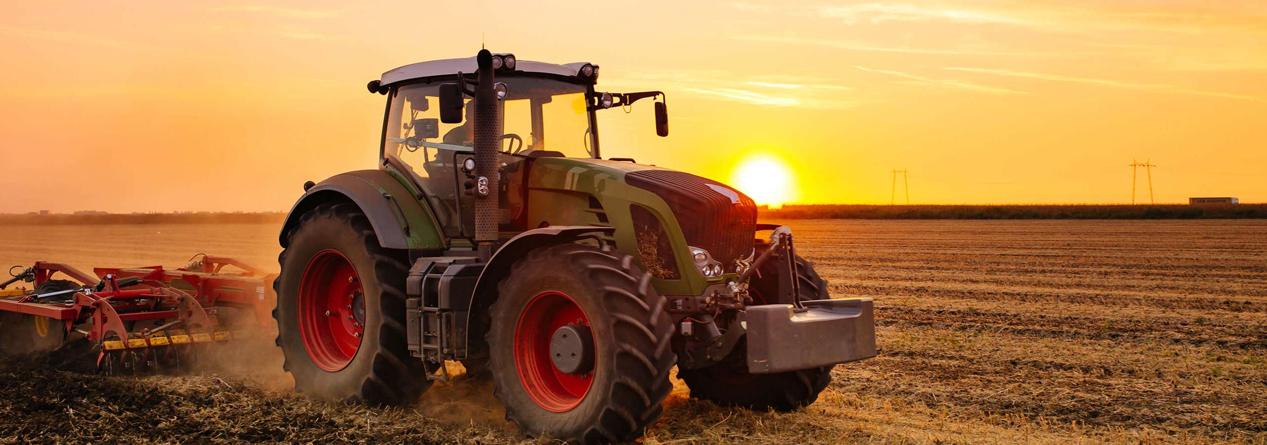 A large agricultural tractor with red wheels
