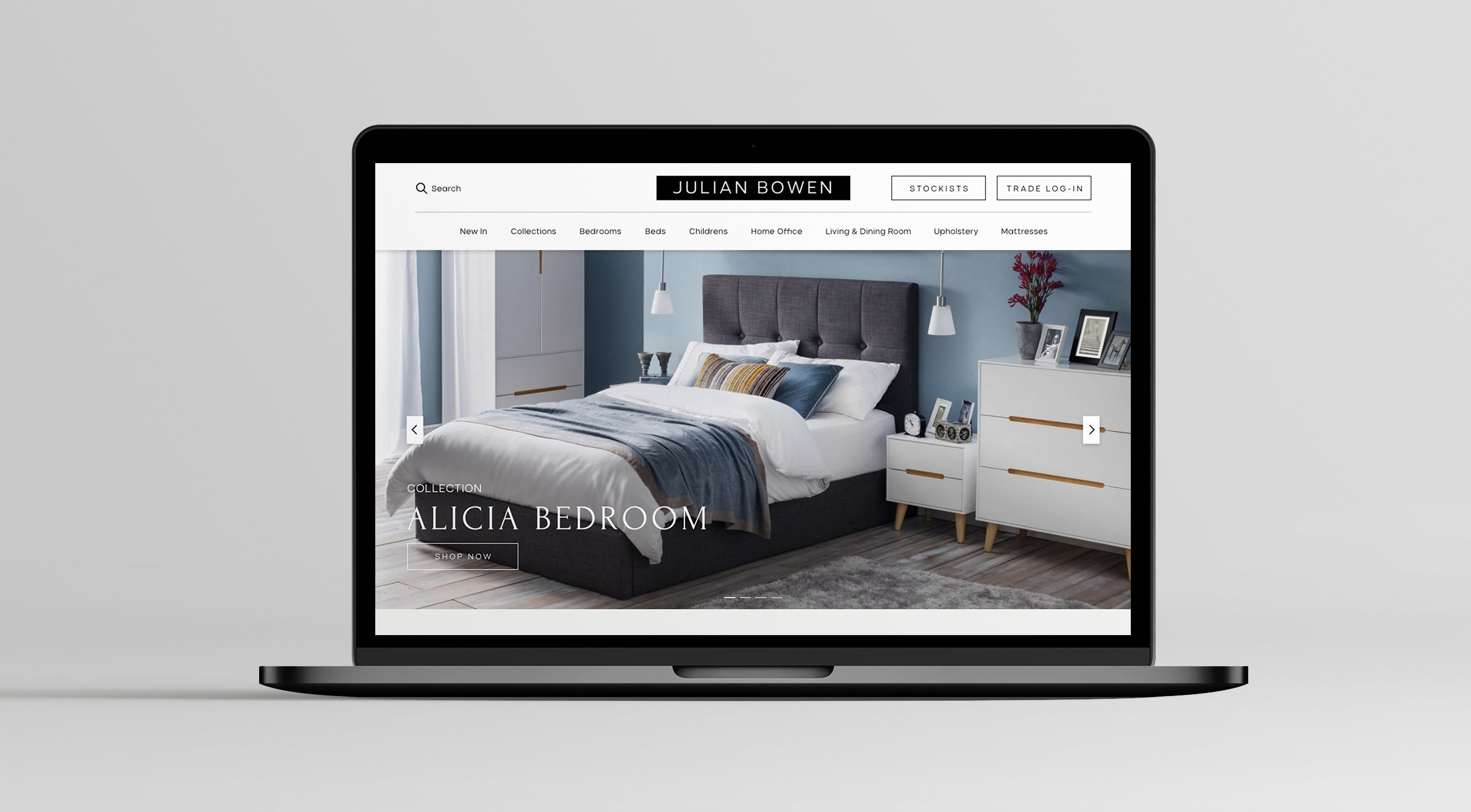 Laptop displaying a bedroom furniture website on a light gray background, following a Shopify migration for Julian Bowen.
