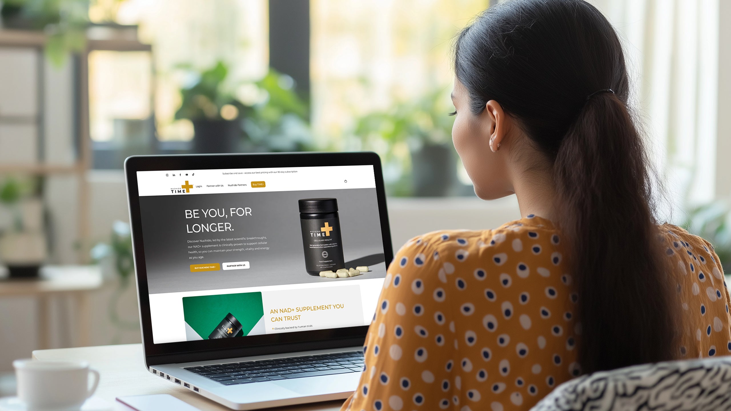 Person with a ponytail looking a website for a vitamins and supplements website on Shopify Plus for Nuchido