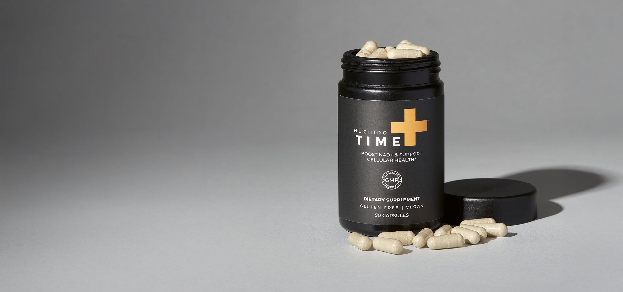 Nuchido NAD+ capsules with dark grey packaging against a light grey background